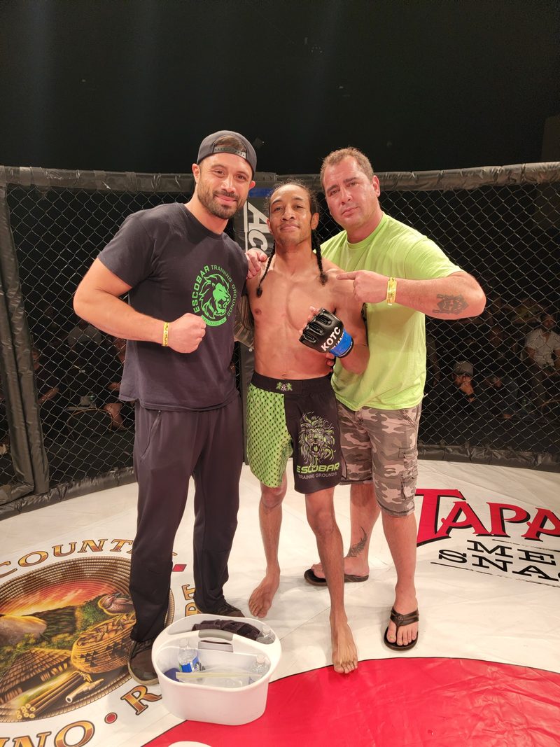 Nick ringside with a fighter and his coach after a bout